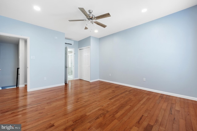 3133 Richmond St, Philadelphia, PA 19134 - unfurnished bedroom with light wood-style floors, baseboards, an AC wall unit, recessed lighting, and ensuite bath