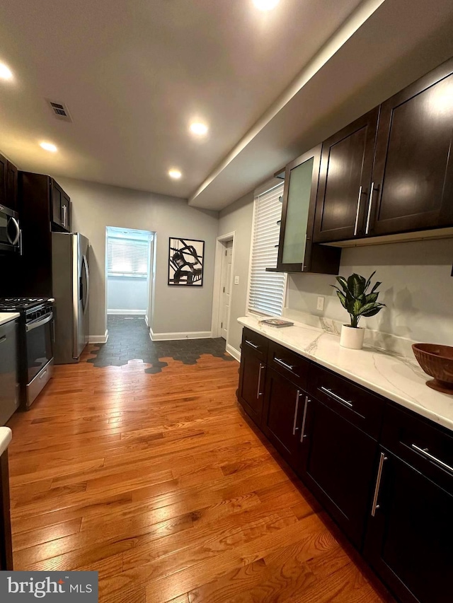 3133 Richmond St, Philadelphia, PA 19134 - kitchen with stainless steel appliances, baseboards, light wood-style flooring, recessed lighting, and light stone countertops
