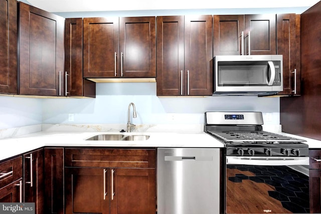 3133 Richmond St, Philadelphia, PA 19134 - kitchen featuring stainless steel appliances, a sink, and dark brown cabinets