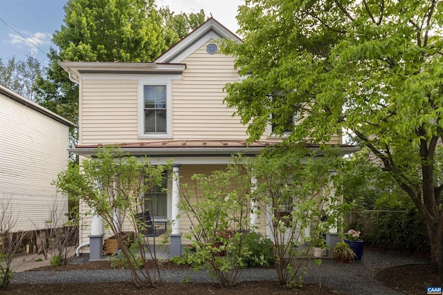 view of front of house featuring a porch and fence