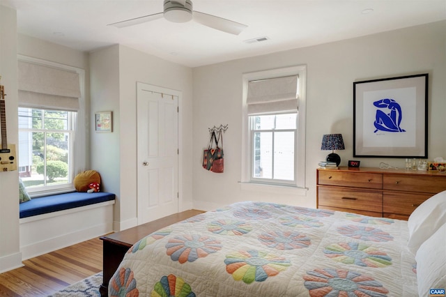 bedroom with wood finished floors, ceiling fan, and baseboards