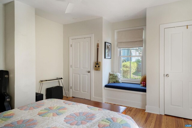 bedroom featuring wood finished floors and baseboards