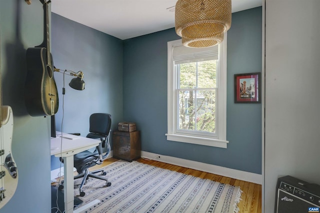 office space with wood finished floors and baseboards