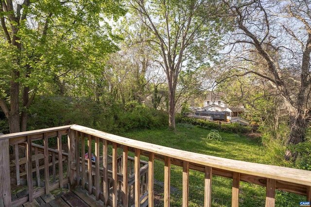 wooden deck with a lawn