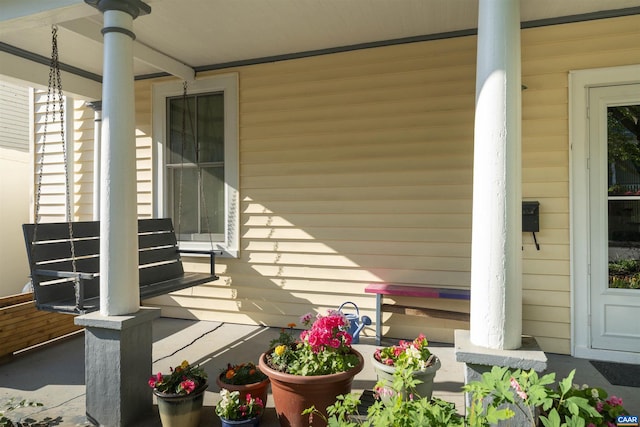 view of side of home featuring covered porch