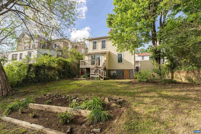 view of green lawn featuring stairway and a deck
