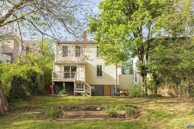 back of house with stairway, a chimney, a lawn, and a wooden deck