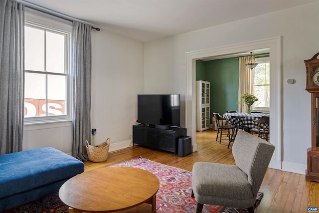 living room featuring wood finished floors and baseboards
