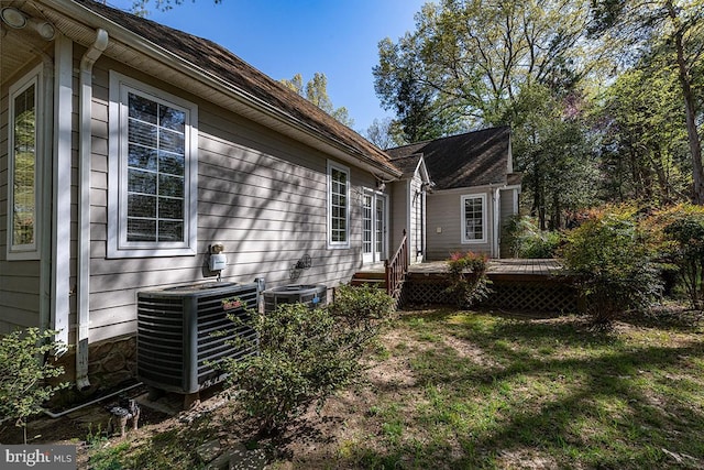 14535 Honeysuckle, Issue, MD 20645 - view of home's exterior featuring central AC unit, a wooden deck, and a yard