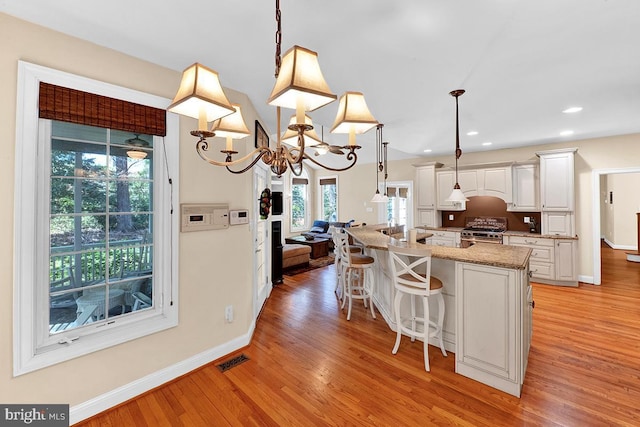 14535 Honeysuckle, Issue, MD 20645 - kitchen featuring high end stainless steel range oven, light wood finished floors, baseboards, white cabinetry, and recessed lighting