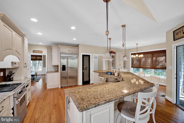 14535 Honeysuckle, Issue, MD 20645 - kitchen with high end appliances, a sink, a chandelier, light wood-style flooring, and recessed lighting