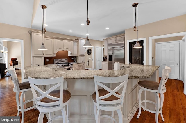 14535 Honeysuckle, Issue, MD 20645 - kitchen with premium appliances, wood finished floors, light stone counters, a sink, and recessed lighting