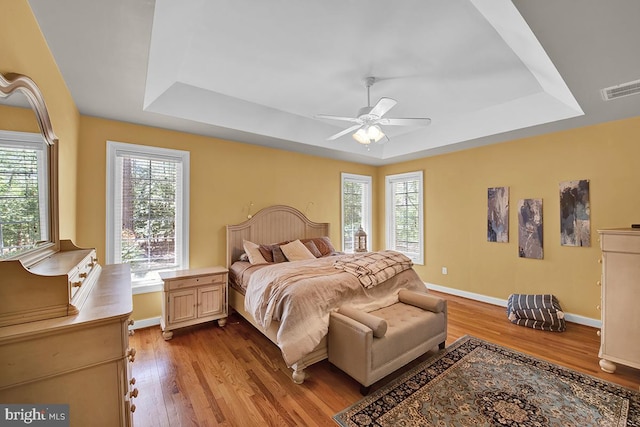 14535 Honeysuckle, Issue, MD 20645 - bedroom with a raised ceiling, wood finished floors, and multiple windows