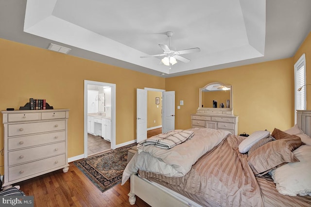 14535 Honeysuckle, Issue, MD 20645 - bedroom with a tray ceiling, wood finished floors, ensuite bathroom, a ceiling fan, and baseboards