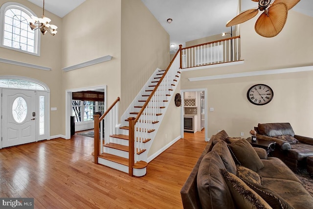 14535 Honeysuckle, Issue, MD 20645 - entryway with a towering ceiling, stairway, hardwood / wood-style flooring, plenty of natural light, and a chandelier