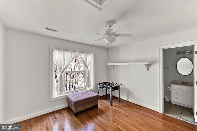 14535 Honeysuckle, Issue, MD 20645 - misc room with baseboards, light wood finished floors, and a ceiling fan