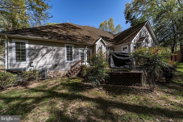14535 Honeysuckle, Issue, MD 20645 - back of property featuring a lawn, a wooden deck, and central AC
