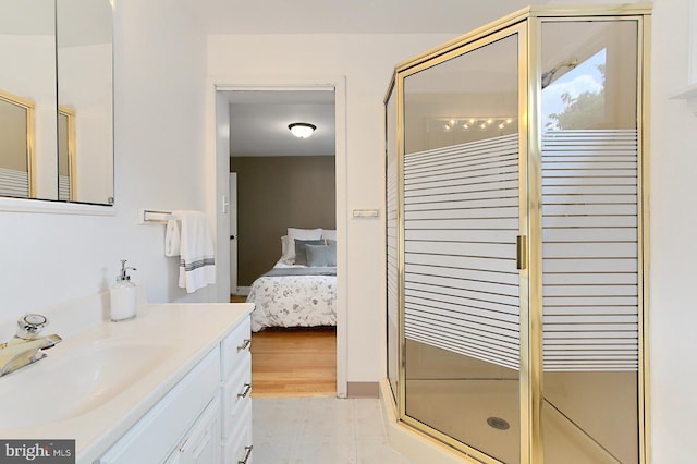 bathroom with ensuite bathroom, a stall shower, and vanity