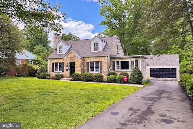 cape cod house featuring stone siding, a chimney, asphalt driveway, and a front lawn