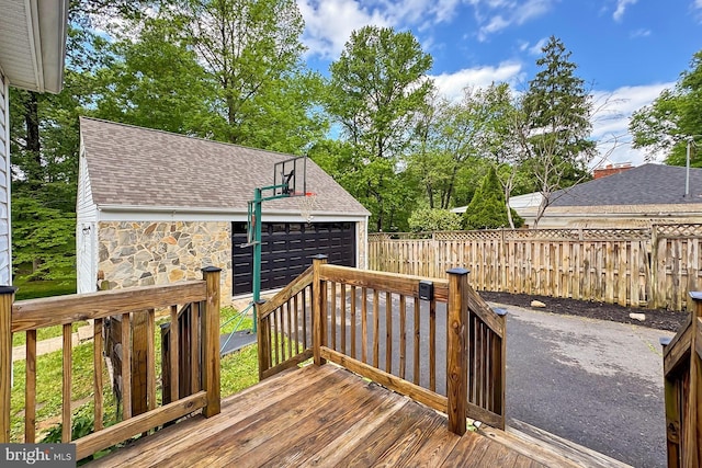 wooden deck featuring an outdoor structure and fence