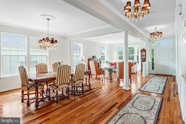 16453 Sparkling Brook Loop, Dumfries, VA 22025 - dining space featuring a chandelier, ornamental molding, light wood-type flooring, and ornate columns