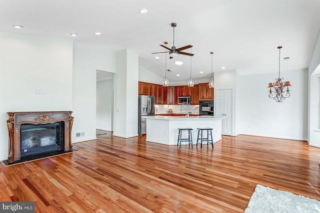 16453 Sparkling Brook Loop, Dumfries, VA 22025 - unfurnished living room featuring a glass covered fireplace, a ceiling fan, light wood-style flooring, a chandelier, and recessed lighting