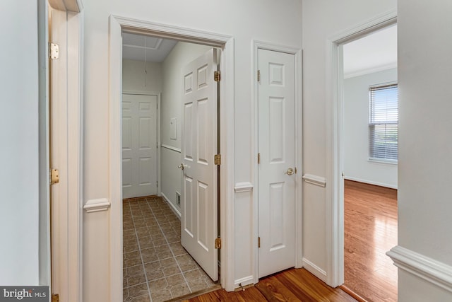 16453 Sparkling Brook Loop, Dumfries, VA 22025 - hallway with attic access, wood finished floors, and ornamental molding