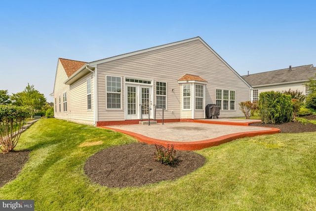 16453 Sparkling Brook Loop, Dumfries, VA 22025 - back of house featuring a patio and a lawn