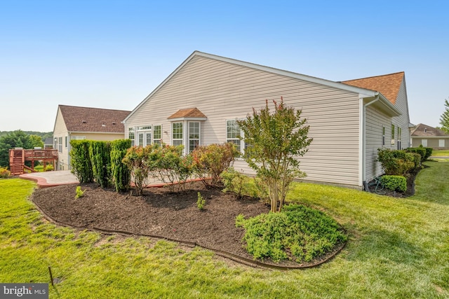 16453 Sparkling Brook Loop, Dumfries, VA 22025 - view of side of home with a yard