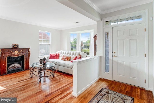 16453 Sparkling Brook Loop, Dumfries, VA 22025 - foyer featuring wood finished floors, crown molding, and a fireplace