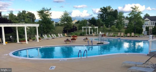 16453 Sparkling Brook Loop, Dumfries, VA 22025 - community pool featuring a pergola and a patio