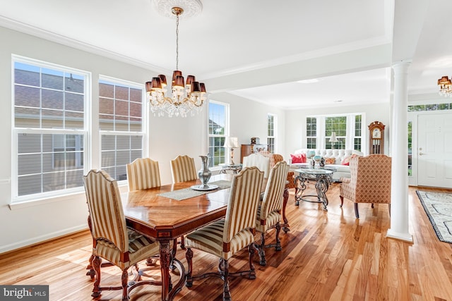 16453 Sparkling Brook Loop, Dumfries, VA 22025 - dining area with a chandelier, ornate columns, light wood-type flooring, and crown molding