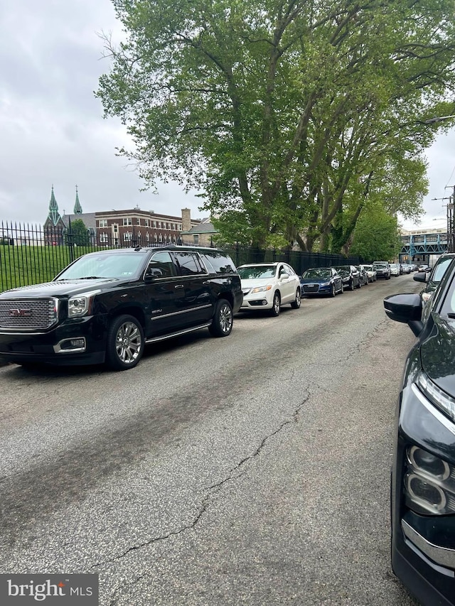 view of car parking featuring fence