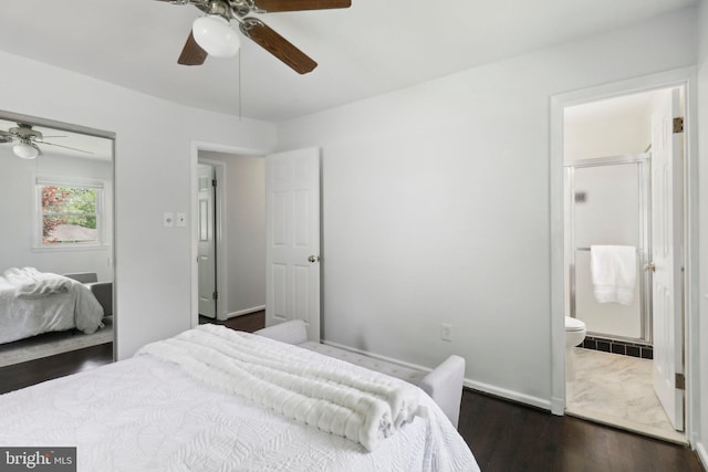bedroom featuring baseboards, ceiling fan, connected bathroom, dark wood-style flooring, and a closet