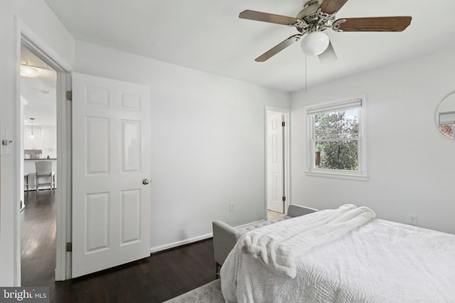 bedroom with wood finished floors, a ceiling fan, and baseboards
