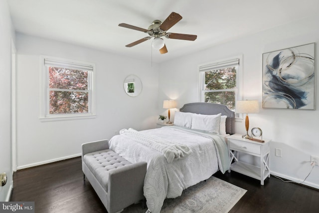bedroom with dark wood-type flooring, baseboards, and a ceiling fan