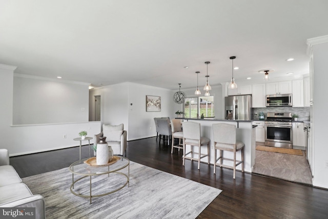 living room with ornamental molding, recessed lighting, and dark wood-style floors