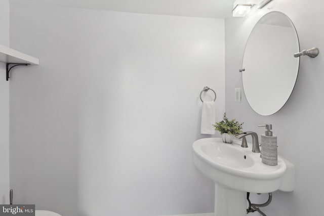 half bath featuring a sink