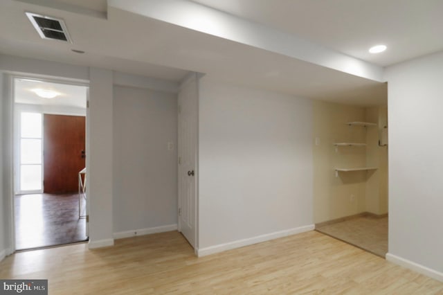 empty room with light wood-style flooring and baseboards