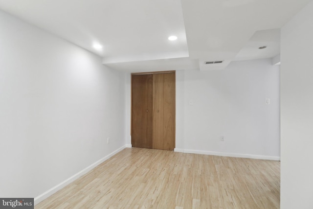 empty room featuring wood finished floors, baseboards, and recessed lighting