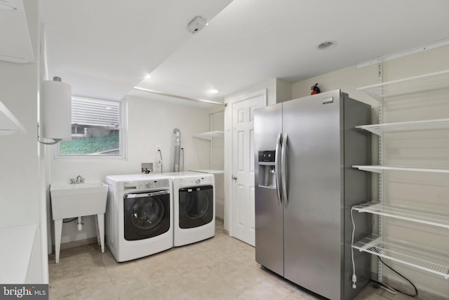 laundry area with separate washer and dryer and recessed lighting