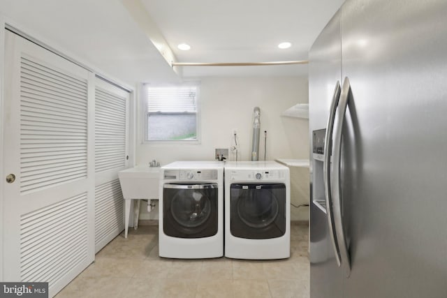 washroom with washing machine and dryer, light tile patterned floors, and recessed lighting