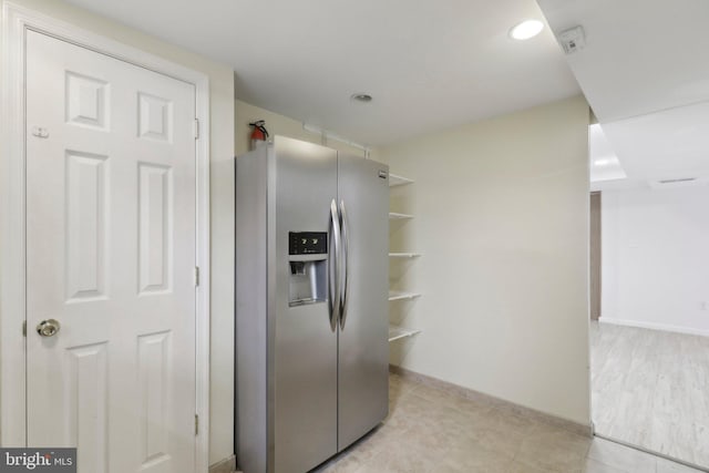 kitchen with stainless steel fridge, open shelves, baseboards, light tile patterned floors, and recessed lighting