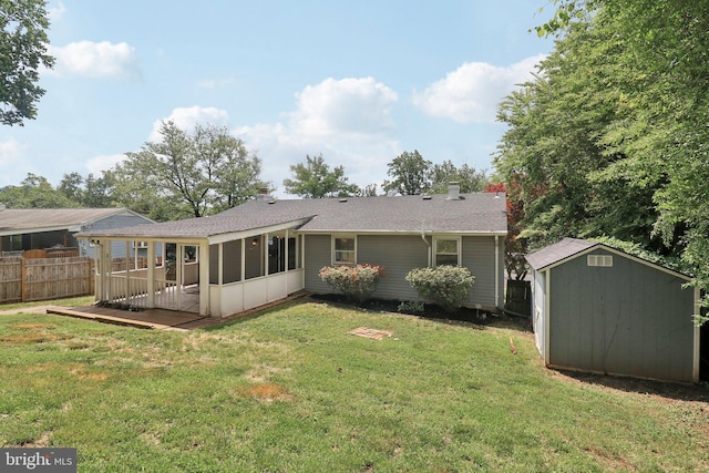 back of property featuring a shed, a sunroom, an outdoor structure, and roof with shingles