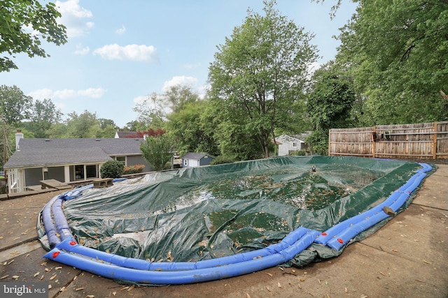 view of pool featuring fence