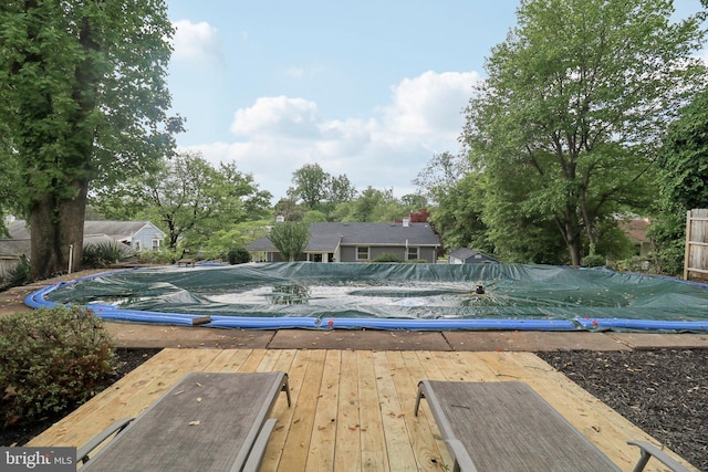 view of swimming pool featuring a wooden deck