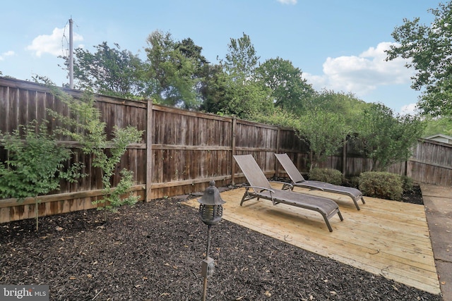 fenced backyard featuring a wooden deck
