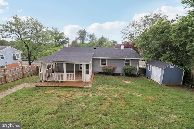 back of house featuring a wooden deck, a chimney, a shed, and an outdoor structure