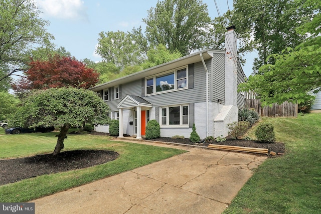 view of front of house featuring a chimney and brick siding