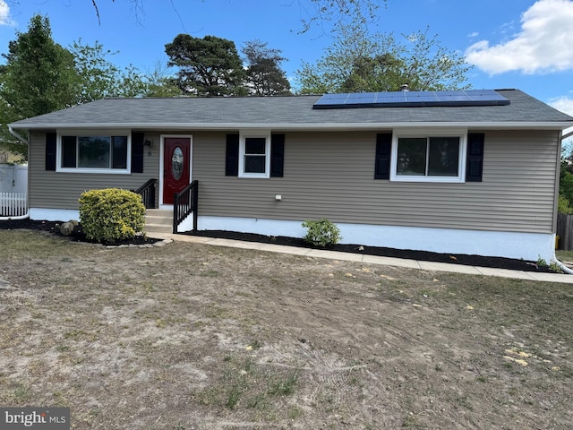 view of front of home featuring roof mounted solar panels